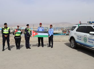 بالصور : الأمن العام يباشر بلصق وتوزيع العلم الأردني على مركبات المواطنين احتفاءً بيوم العلم