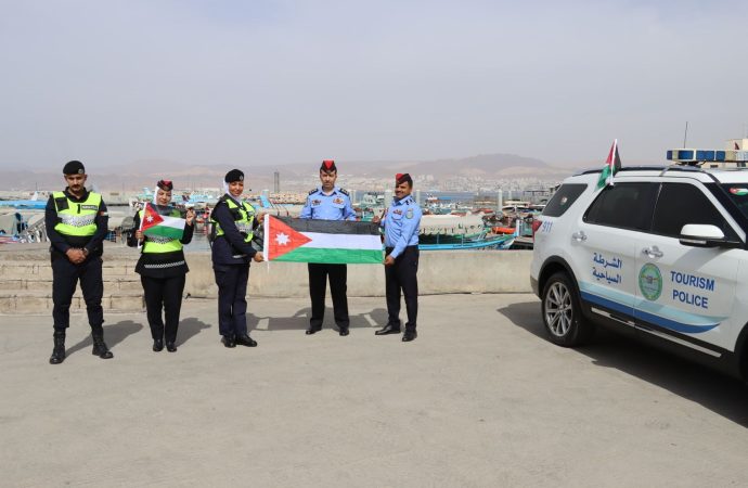 بالصور : الأمن العام يباشر بلصق وتوزيع العلم الأردني على مركبات المواطنين احتفاءً بيوم العلم